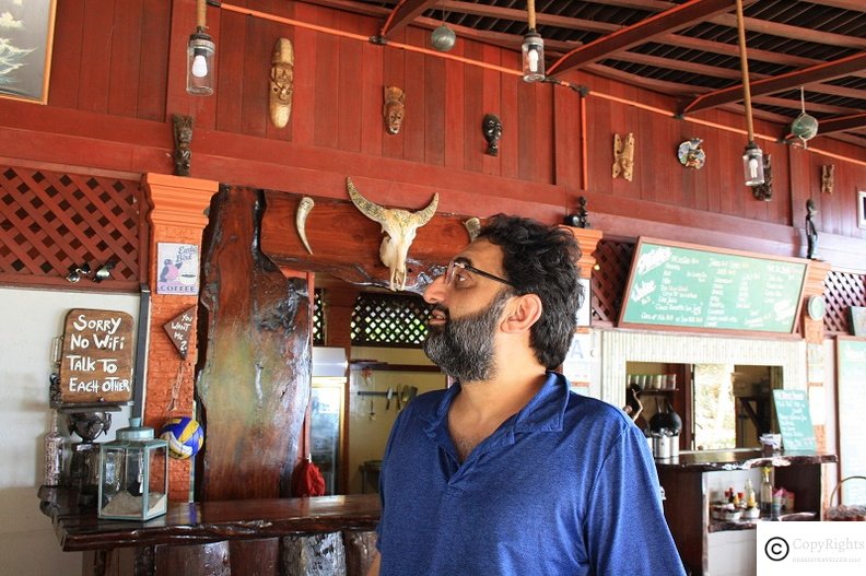 Mr Khan enjoying cafe managed by a European couple. 